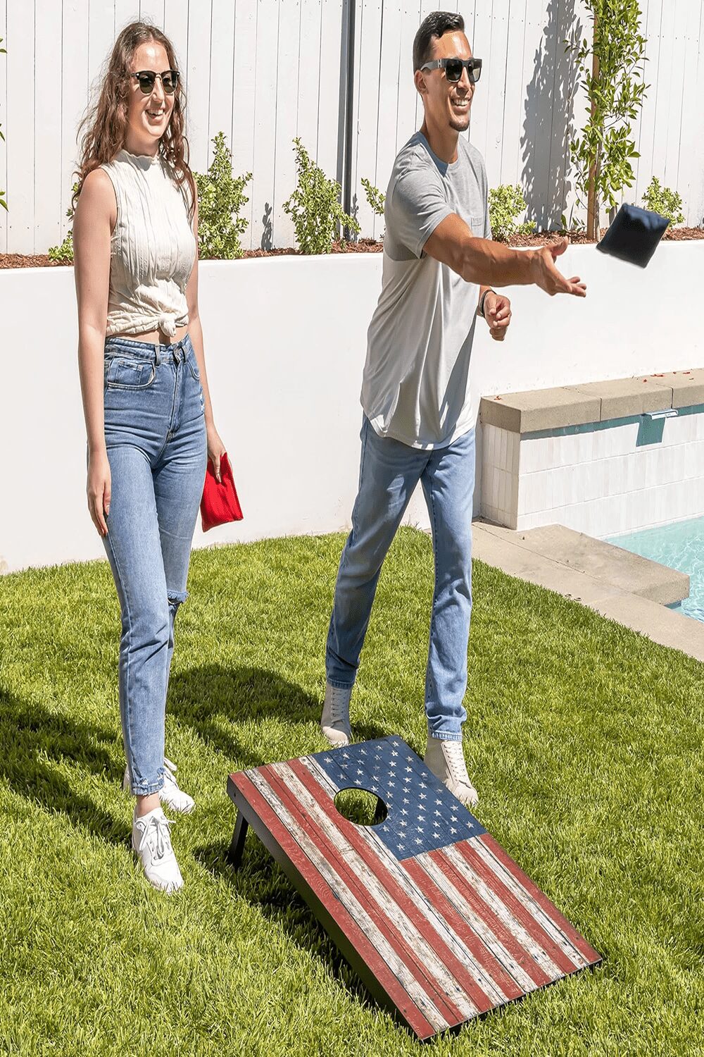 a man and woman playing cornhole corn corn corn corn corn corn corn corn corn